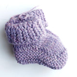 Handmade knitted baby socks in lila with folded ankle cuffs, made from 100% baby alpaca wool—soft, stretchy, and perfect for little feet.