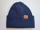 Blue knit beanie with a 'YANANTIN' brand label on a light gray background