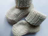 Pile of baby alpaca woolen sweaters is radiant colors. Sweaters are unorganised, but you can see their pattern and details. 