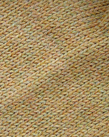 Close-up of the soft knitted texture of the handmade light yellow baby hat, made from 100% baby alpaca wool.