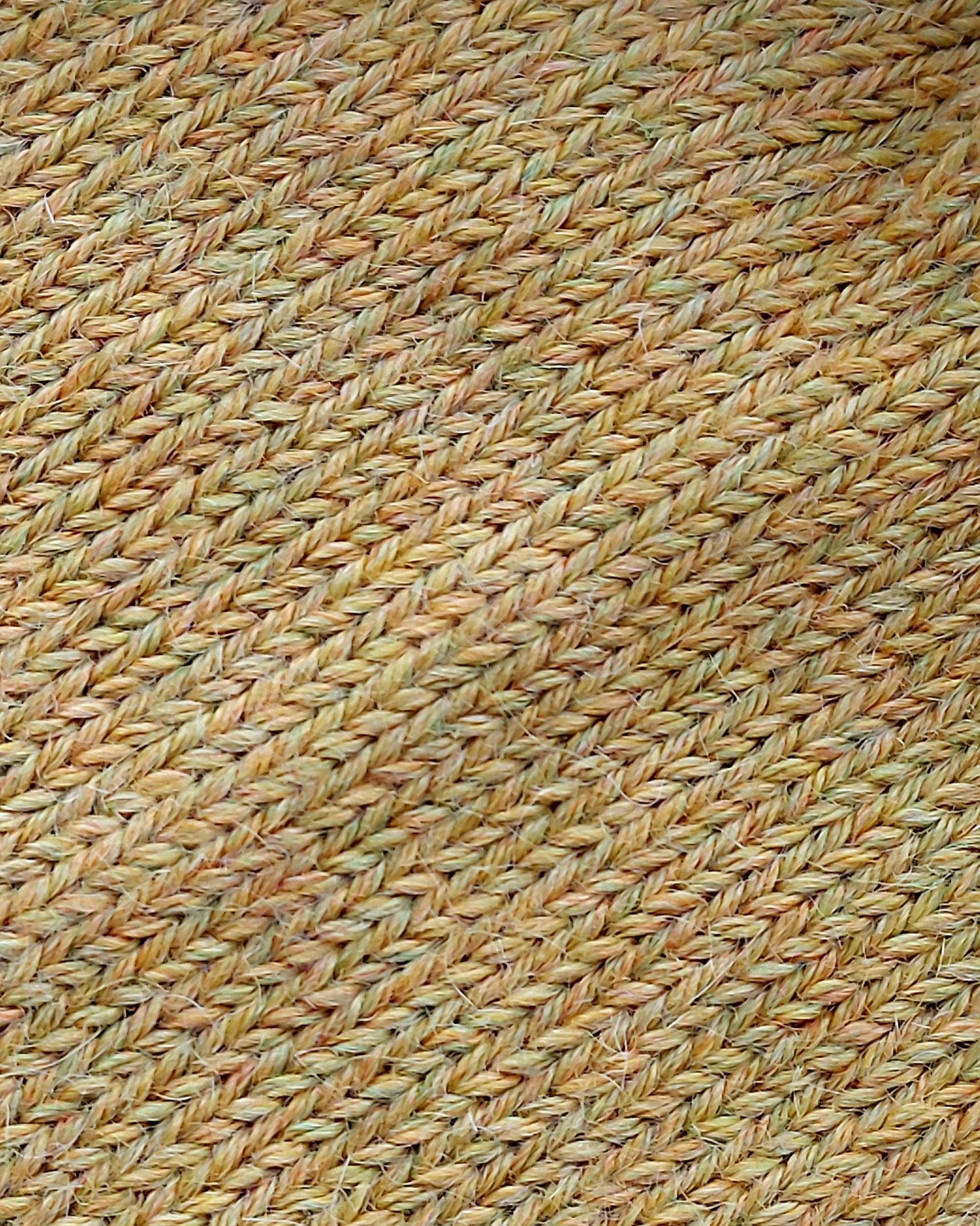Close-up of the soft knitted texture of the handmade light yellow baby hat, made from 100% baby alpaca wool.