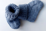 Handmade knitted baby socks in light blue with folded ankle cuffs, made from 100% baby alpaca wool—soft, stretchy, and perfect for little feet.