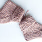 Handmade knitted baby socks in light pink with folded ankle cuffs, made from 100% baby alpaca wool—soft, stretchy, and perfect for little feet.