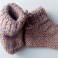 Handmade knitted baby socks in light pink with folded ankle cuffs, made from 100% baby alpaca wool—soft, stretchy, and perfect for little feet.