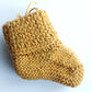 Handmade knitted baby socks in ochre yellow with folded ankle cuffs, made from 100% baby alpaca wool, soft and stretchy.