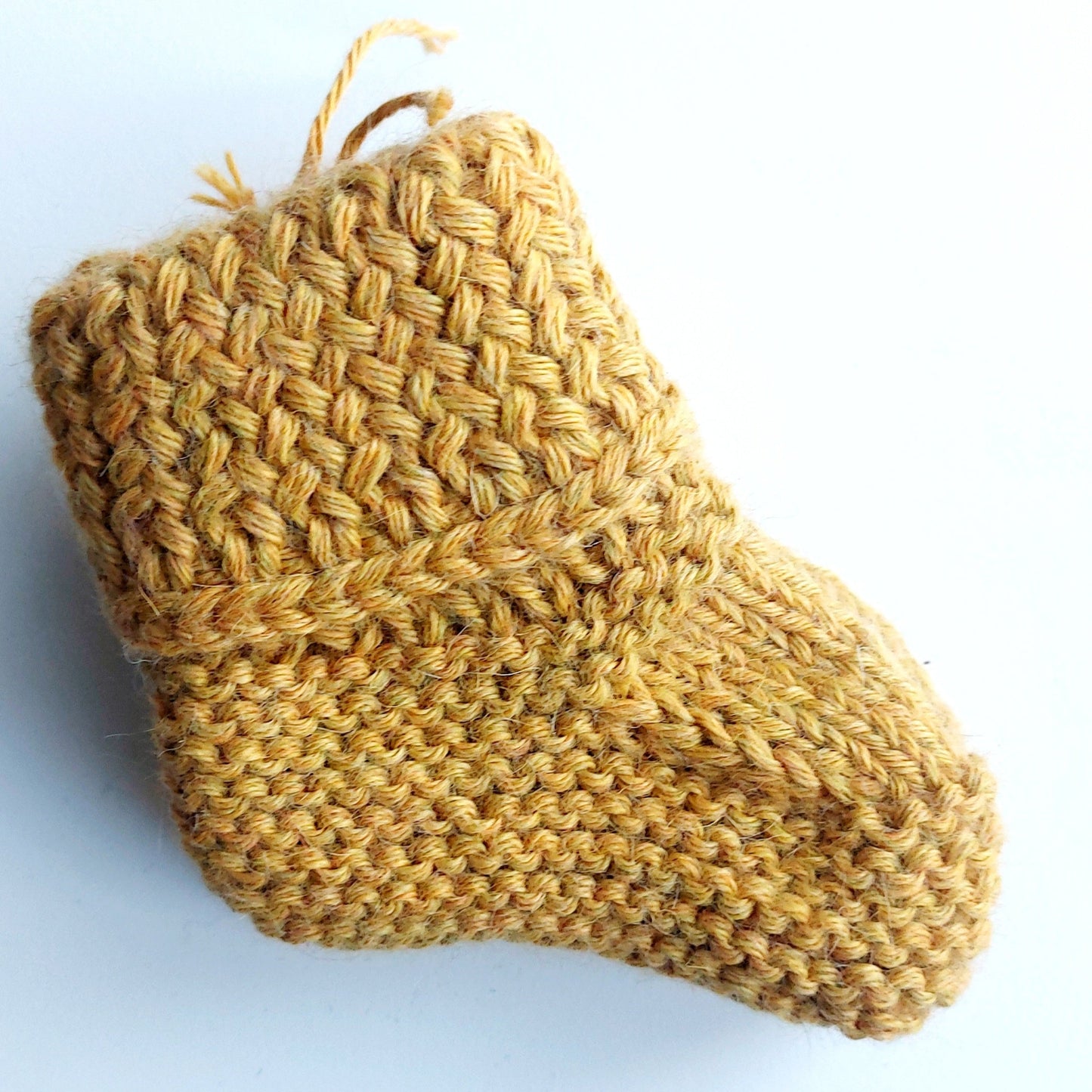 Handmade knitted baby socks in ochre yellow with folded ankle cuffs, made from 100% baby alpaca wool, soft and stretchy.