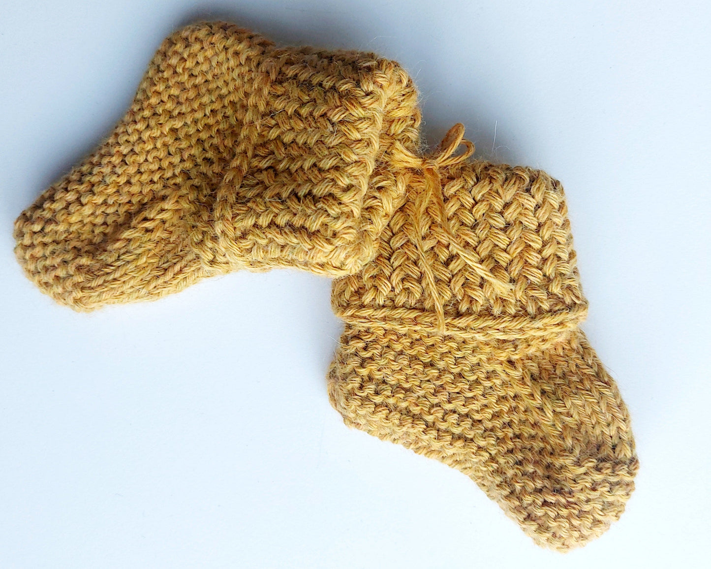 Handmade knitted baby socks in ochre yellow with folded ankle cuffs, made from 100% baby alpaca wool, soft and stretchy.