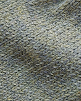 Close-up of the soft knitted texture of the handmade light green baby hat, made from 100% baby alpaca wool with a foldable edge and pompom.