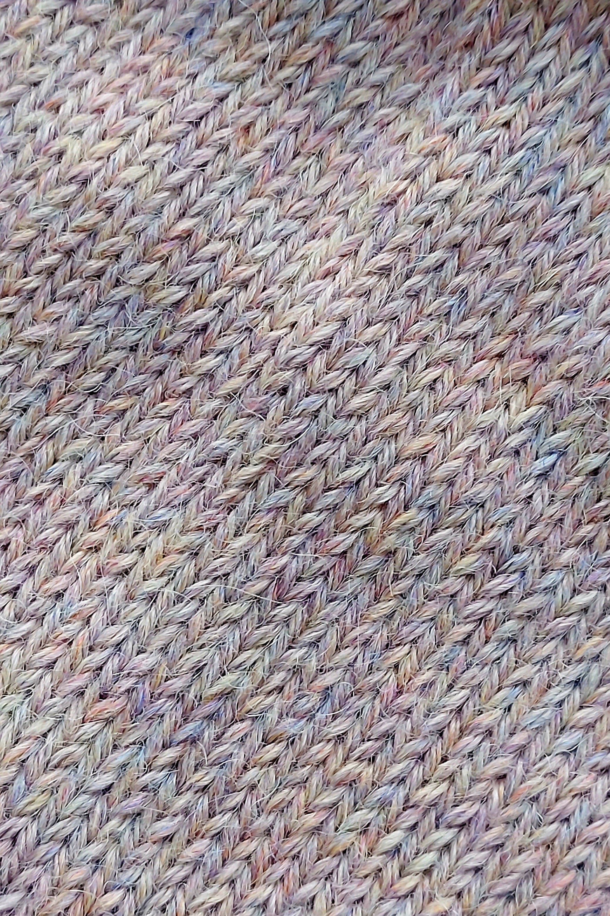 Close-up of the knitted texture on the handmade light pink baby hat, made from 100% baby alpaca wool.