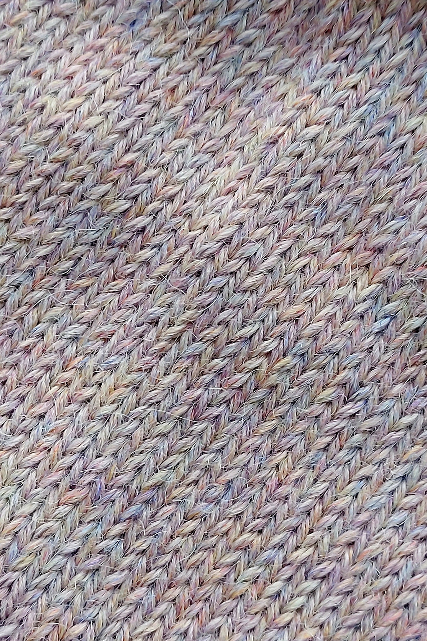 Close-up of the knitted texture on the handmade light pink baby hat, made from 100% baby alpaca wool.