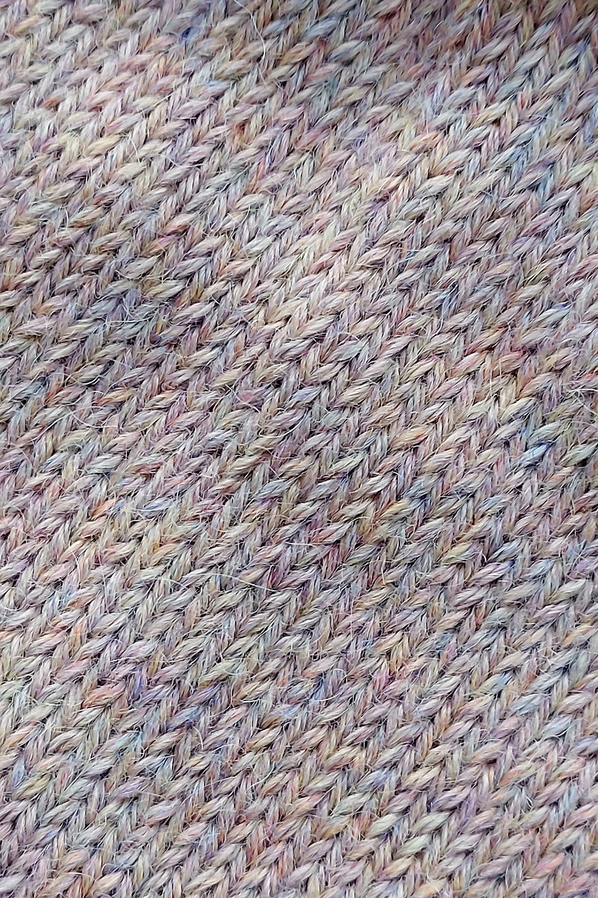 Close-up of the knitted texture on the handmade light pink baby hat, made from 100% baby alpaca wool.