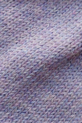 Close-up of the soft knitted texture of the handmade lila baby hat, made from 100% baby alpaca wool with a foldable edge and pompom.
