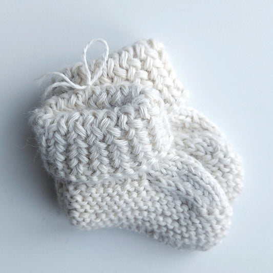 Handmade knitted baby socks with folded ankle cuffs, made from 100% baby alpaca wool, soft and stretchy.