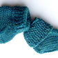 Handmade knitted baby socks in peacock blue with folded ankle cuffs, made from 100% baby alpaca wool, soft and stretchy.