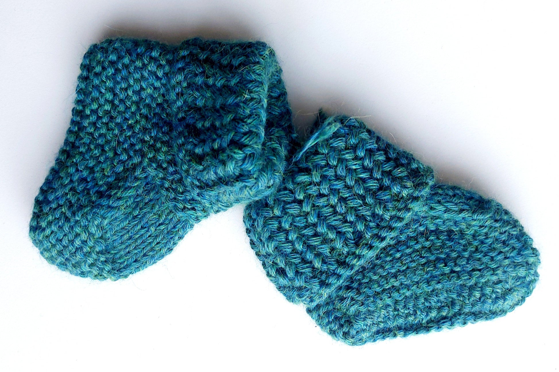 Handmade knitted baby socks in peacock blue with folded ankle cuffs, made from 100% baby alpaca wool, soft and stretchy.