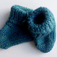 Handmade knitted baby socks in peacock blue with folded ankle cuffs, made from 100% baby alpaca wool, soft and stretchy.