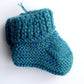 Handmade knitted baby socks in peacock blue with folded ankle cuffs, made from 100% baby alpaca wool, soft and stretchy.