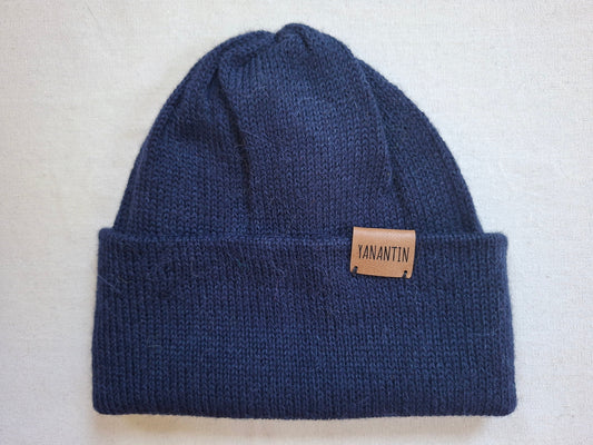 Blue knit beanie with a 'YANANTIN' brand label on a light gray background