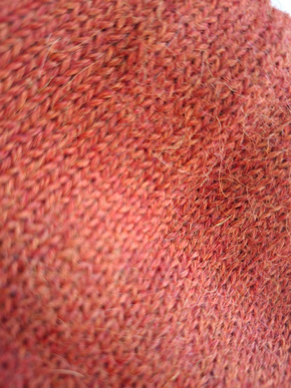Close-up of a textured orange wool fabric surface