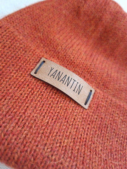 Orange alpaca wool knit hat with a 'YANANTIN' label on a white background