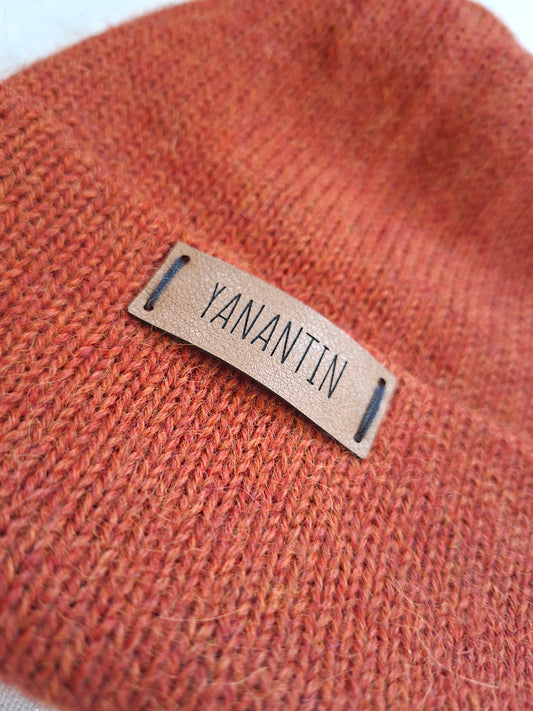 Orange alpaca wool knit hat with a 'YANANTIN' label on a white background